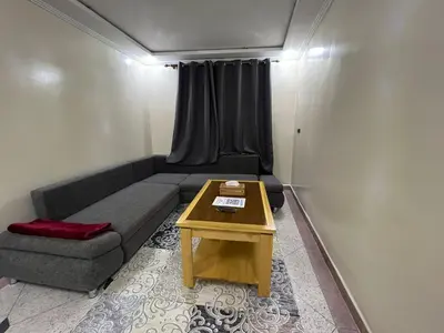 a small living room with a couch and a table at DIAAFATE TANNIRTE in Khenifra