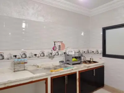 a kitchen with a sink and a white wall at DIAAFATE TANNIRTE in Khenifra