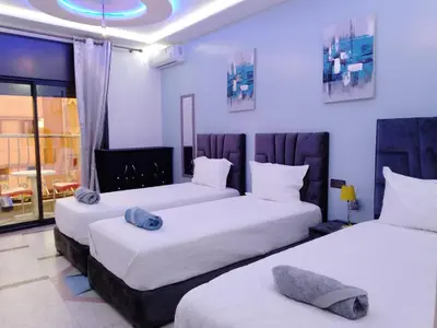 two beds in a room with white walls at DIAAFATE TANNIRTE in Khenifra