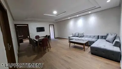 a living room with a couch and a table at Hotel Jaouharat Ismaili in Meknès