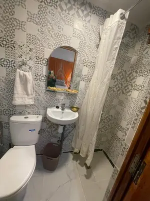 a bathroom with a toilet and a sink and a mirror at DAR ALKATIB MEKNES in Meknès