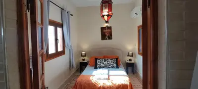 a bedroom with a bed in a room with a window at DAR ALKATIB MEKNES in Meknès