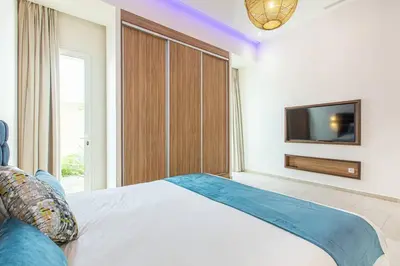 a bedroom with a large bed and a tv at Villa Safiya, luxe et détente, jeux, cuisinière in Marrakech