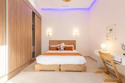 a bedroom with a large bed and a desk at Villa Safiya, luxe et détente, jeux, cuisinière in Marrakech