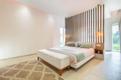 a bedroom with a large bed and a large window at Villa Safiya, luxe et détente, jeux, cuisinière in Marrakech