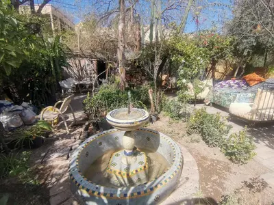 a fountain with a sink in a garden at Studio avec piscine et parking prive in Fès