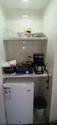 a small kitchen with a stove and a pot on a shelf at Studio avec piscine et parking prive in Fès