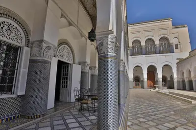 a courtyard of a building with columns and a gate at Studio avec piscine et parking prive in Fès