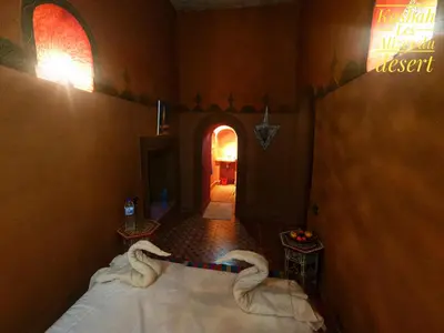 a room with a bed with swans on it at Kasbah Les Alizes Du Desert in Mhamid