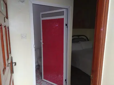 an open door to a bedroom with a bed at gîte d'étape ziz oasis in Achbarou
