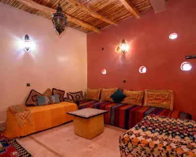 a living room with a couch and a table at Dar badiawarda in Azilal