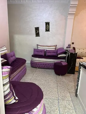 a living room with purple couches and a purple rug at NADIA BELVUE 3 in Meknès