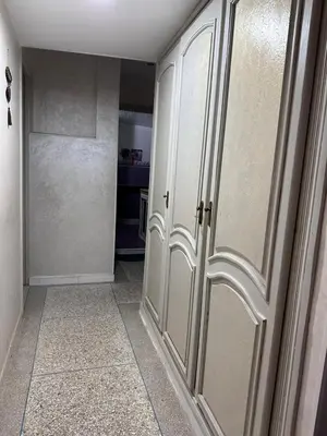 a hallway with white cabinets in a room at NADIA BELVUE 3 in Meknès