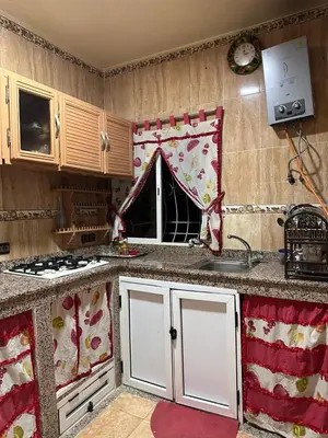 a kitchen with a sink and a stove top oven at NADIA BELVUE 3 in Meknès