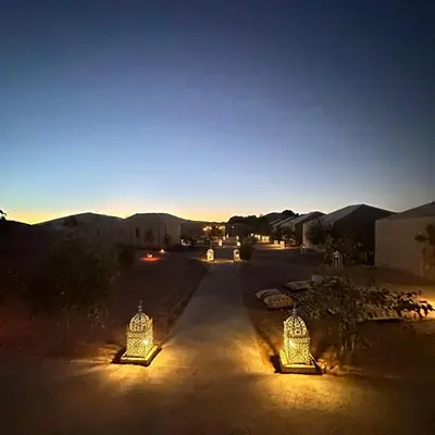 a group of lights in the desert at night at Desert Paradise Luxury Camp in Merzouga