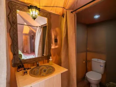 a bathroom with a sink and a mirror at Desert Paradise Luxury Camp in Merzouga