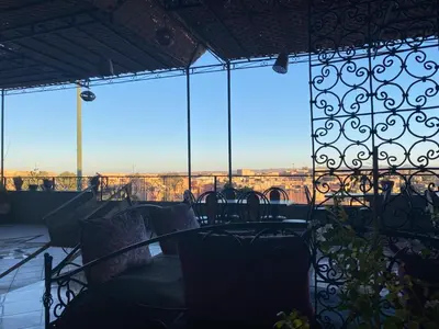a balcony with a couch and some windows at APPART AIGLE HOTEL in Ouarzazate