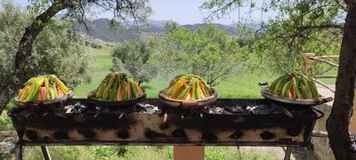 three pots of bananas on top of a grill at Houcine gite in Taza