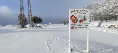 a sign in the snow with footprints in the snow at Houcine gite in Taza