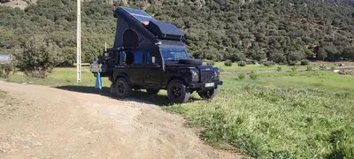 a truck parked on the side of a dirt road at Houcine gite in Taza