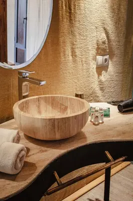 a wooden sink on a counter in a bathroom at Merzouga luxury desert camps in Merzouga