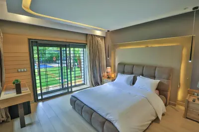 a bedroom with a large bed and a large window at Riad Bella Montana in Fès