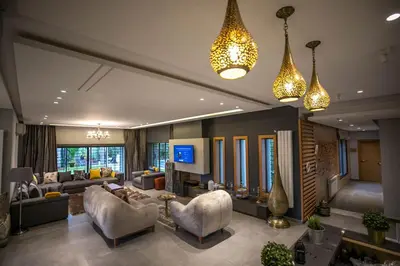a living room with couches and chairs and lights at Riad Bella Montana in Fès