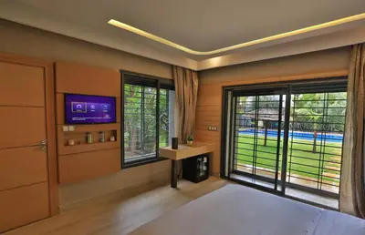 a bedroom with a bed and a tv and windows at Riad Bella Montana in Fès