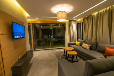 a living room with a couch and a tv at Riad Bella Montana in Fès