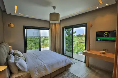 a bedroom with a bed and a large window at Riad Bella Montana in Fès