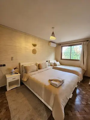 a bedroom with a large bed and a window at Residence Imlil Ouarzazate in Ouarzazate