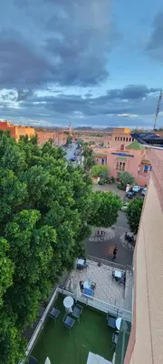 an overhead view of a courtyard with chairs and trees at Residence Imlil Ouarzazate in Ouarzazate