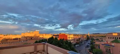 a view of a city with a cloudy sky at Residence Imlil Ouarzazate in Ouarzazate