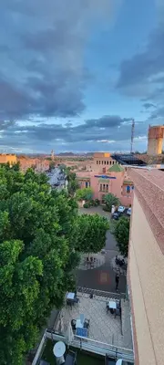 an overhead view of a courtyard with chairs and trees at Residence Imlil Ouarzazate in Ouarzazate