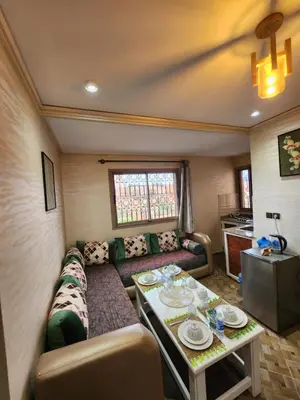 a living room with a couch and a table at Residence Imlil Ouarzazate in Ouarzazate
