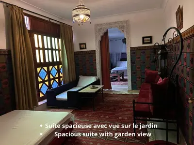 a living room with a couch and a chair at Villa DALIA - artistic and Cultural Residence in Aghmat
