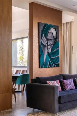 a living room with a painting on the wall at Villa Roseraie Isabella in Marrakech