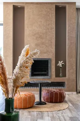 a living room with a fireplace with pumpkins and a table at Villa Roseraie Isabella in Marrakech