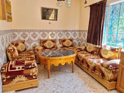 a living room with a couch and a coffee table at Maison Touria in Ouzoud