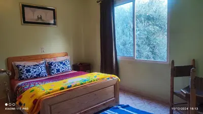 a bedroom with a bed and a window at Maison Touria in Ouzoud