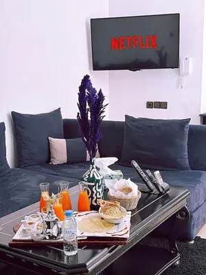 a living room with a couch with a table with food on it at Residence Chay - Appartement de luxe in Ouarzazate