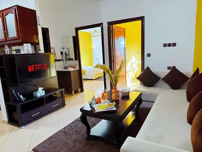 a living room with a couch and a tv at Residence Chay - Appartement de luxe in Ouarzazate