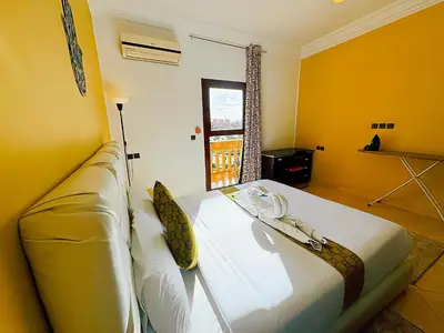 a yellow room with a couch and a window at Residence Chay - Appartement de luxe in Ouarzazate
