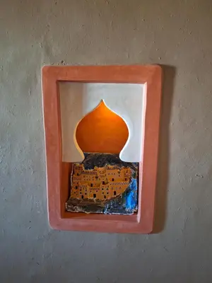 a picture of a framed picture of a building at Riad Merzouga Dunes in Merzouga