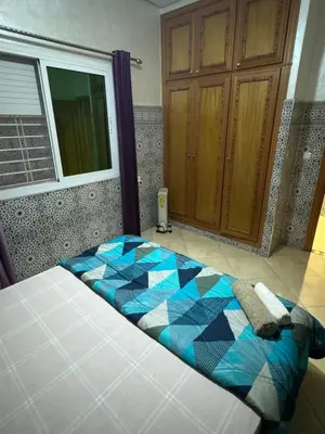 a bed in a room with at A appartement in Fès