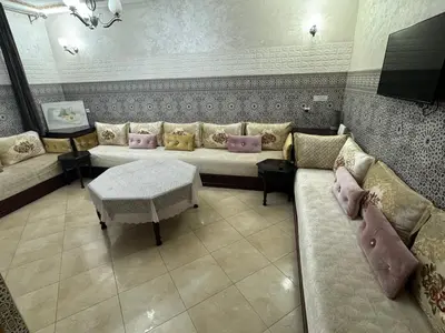 a living room with a couch and a table at A appartement in Fès