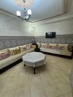 a living room with a couch and a table at A appartement in Fès