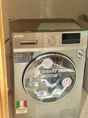 a washing machine with stickers on the front of it at A appartement in Fès