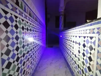 a room with a tiled wall and purple lights at Appart Artisanal sur Fez in Fès