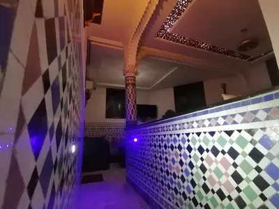 a room with a tile wall and purple lights at Appart Artisanal sur Fez in Fès